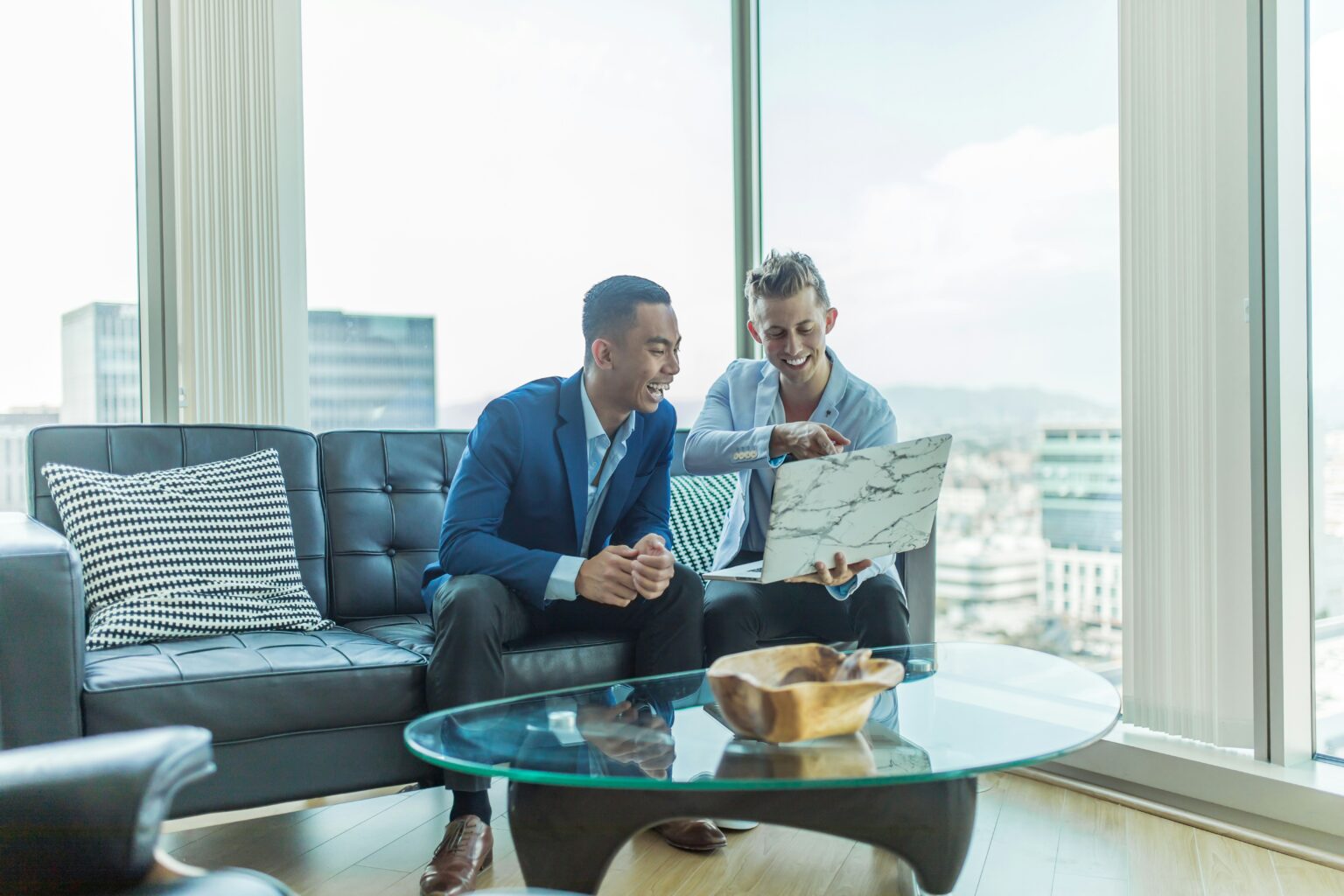 Two men looking at a laptop