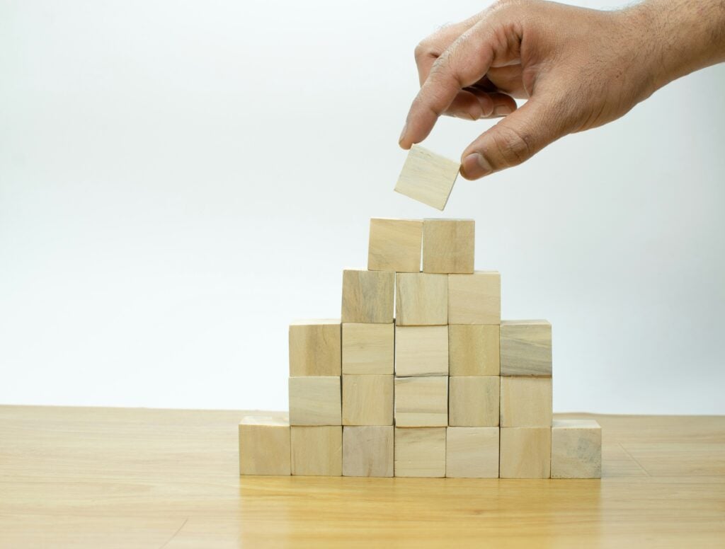 Wooden blocks getting stacked on top of one another