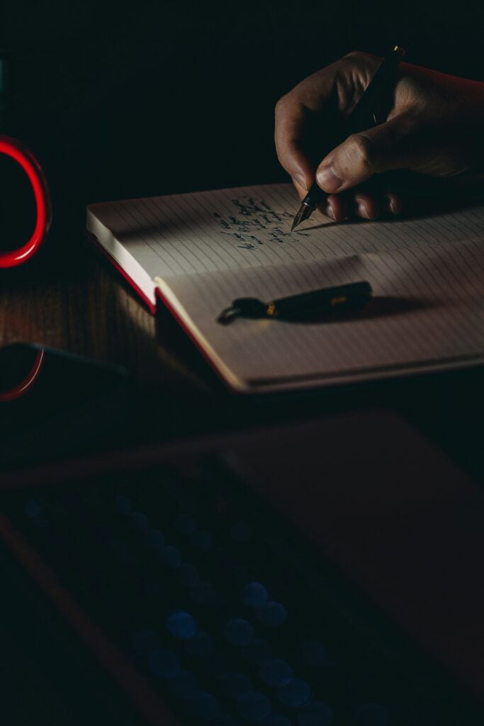 A man writing in his notebook