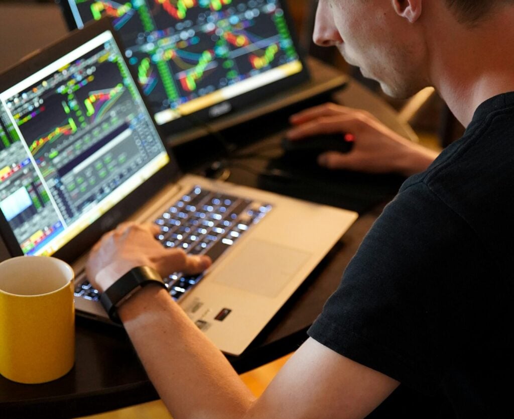 A man working on a laptop whilst trading