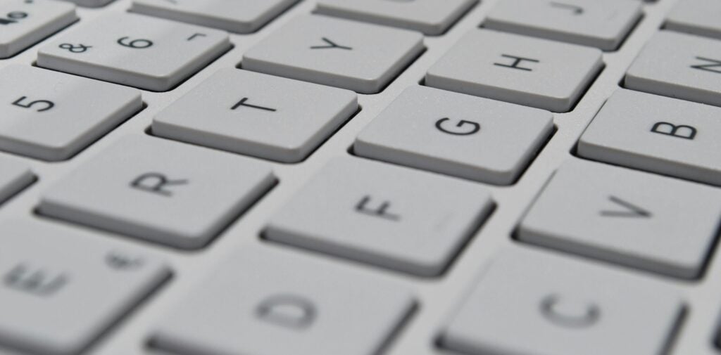A close up of a keyboard connected to a computer