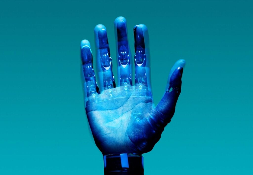 A robotic hand in the air with a blue background