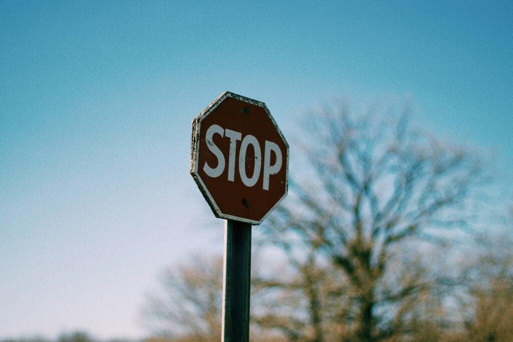 A stop sign with a blue sky behind
