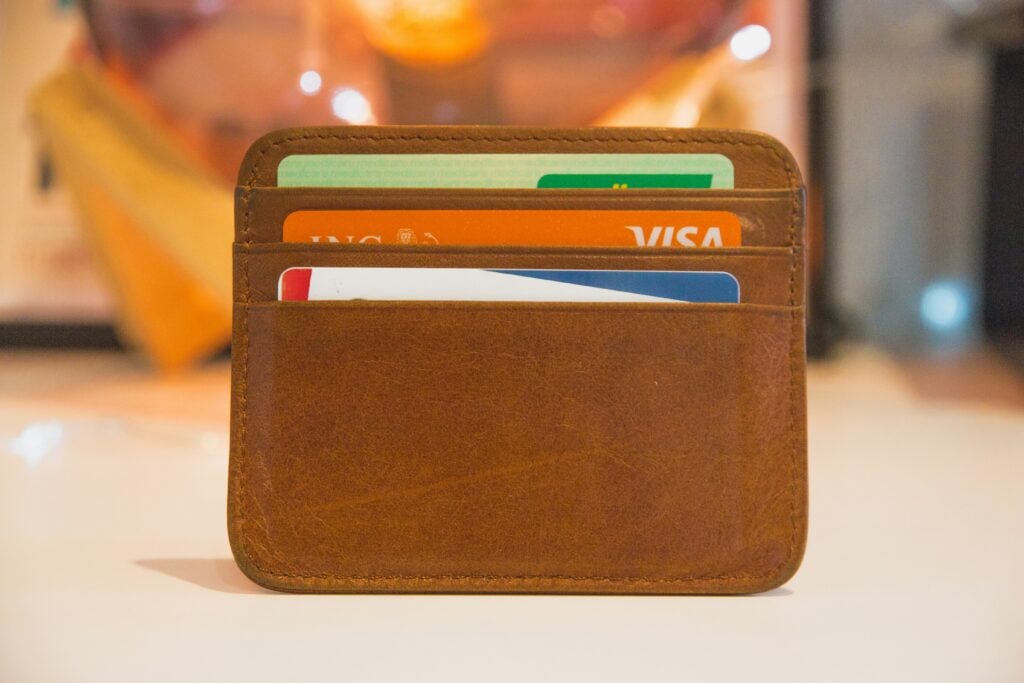 Three cards in a small brown wallet