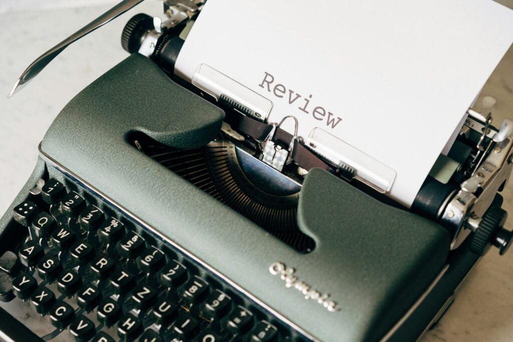 A typewriter showing a page with Review as the page title