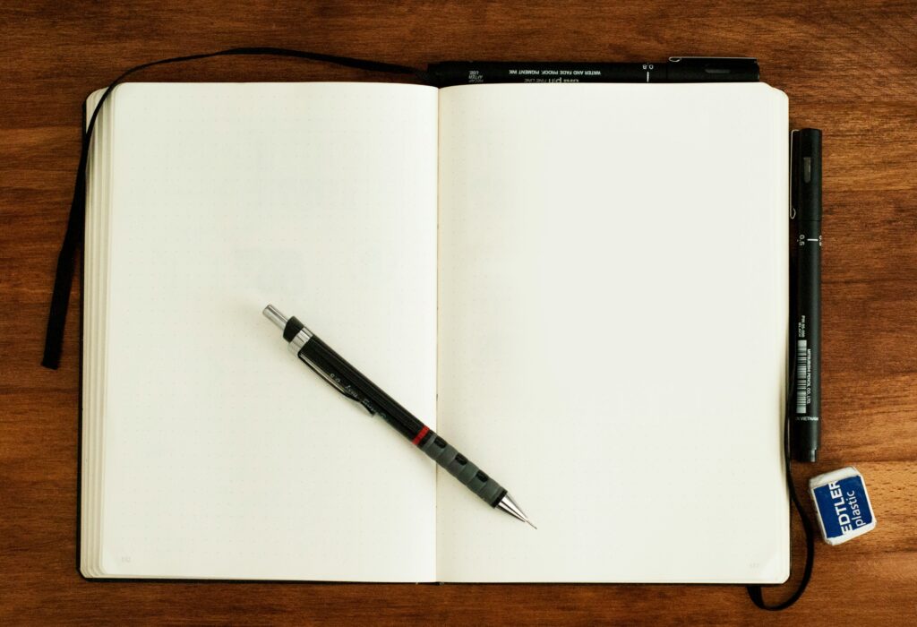An open notebook with a pen, ready to take notes