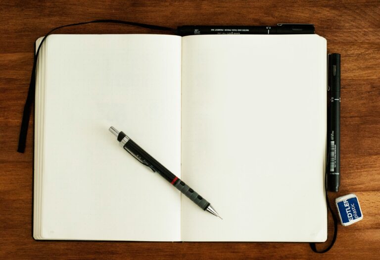 An open notebook with a pen, ready to take notes